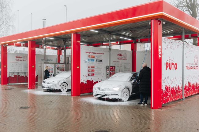 Two cars with foam in Puto car wash in Riga