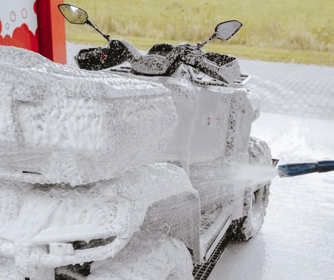 Quad bike covered in foam at PUTO car wash.