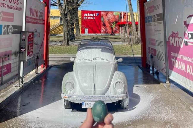 Car covered in foam at PUTO self-service car wash with a holiday egg in the foreground.