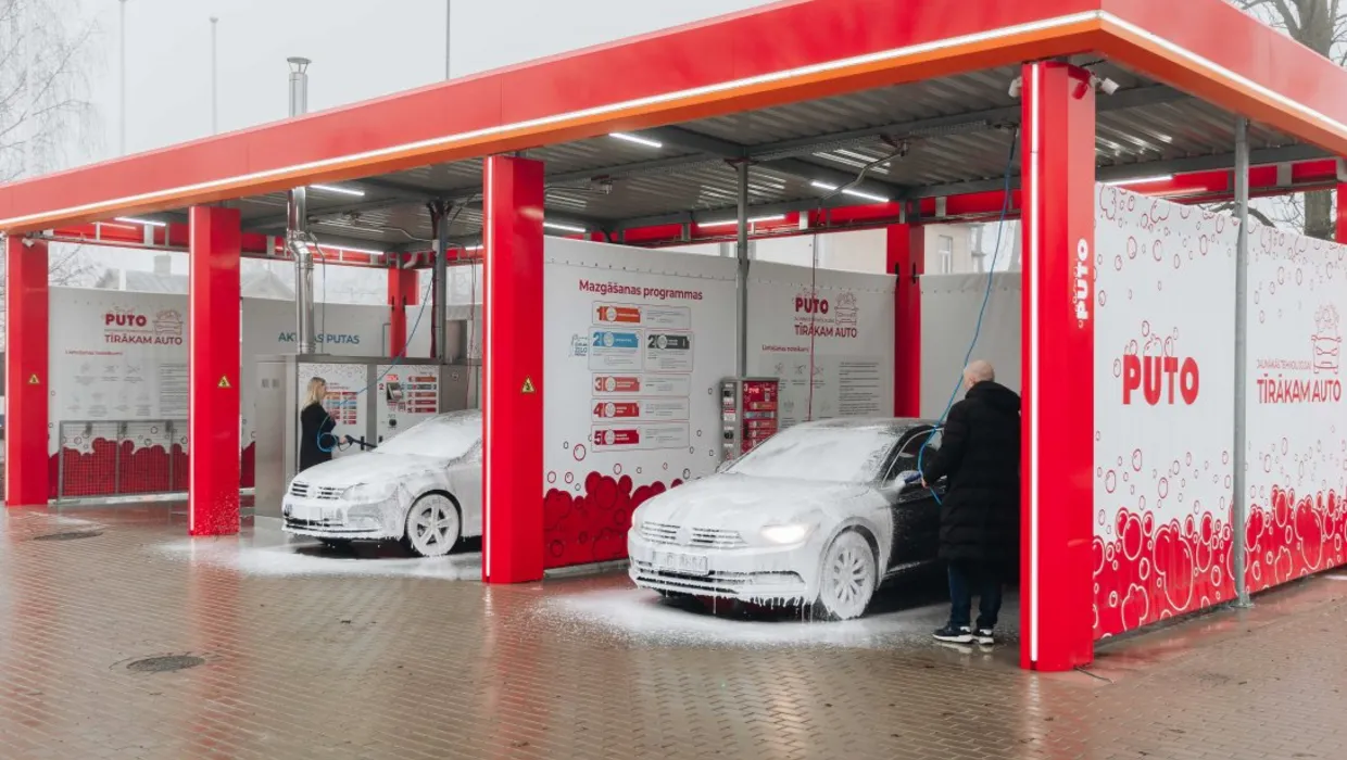 Two cars with foam in Puto car wash in Riga